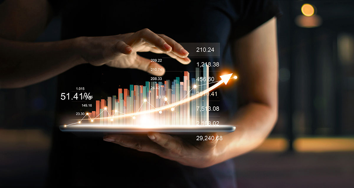 Businessperson with tablet and sales data