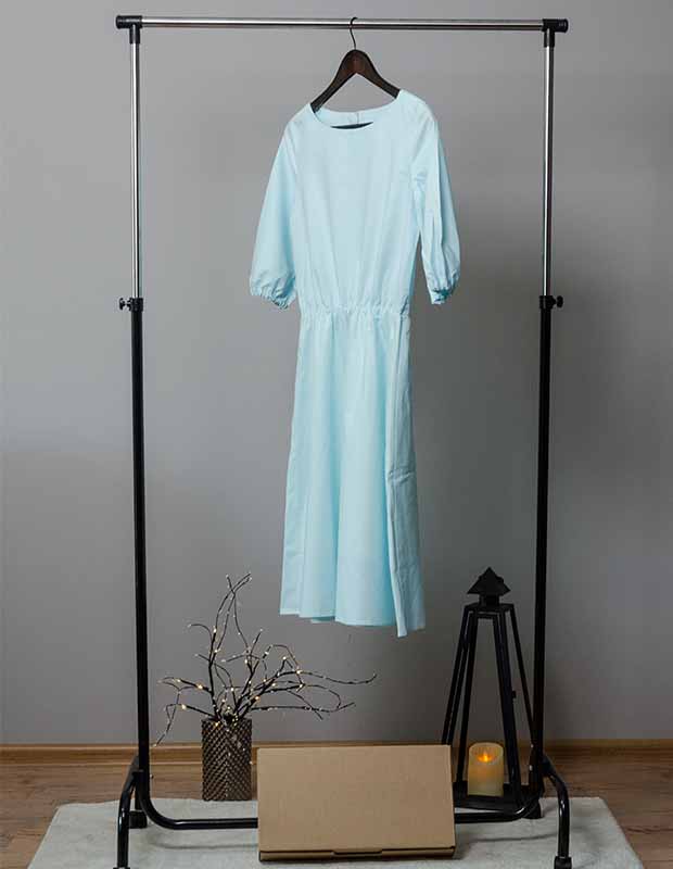High-end dress rental hanging on a rack at home 