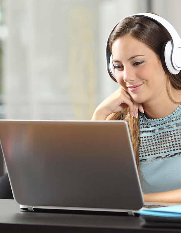 Woman listening to a digital upskilling webinar on her laptop
