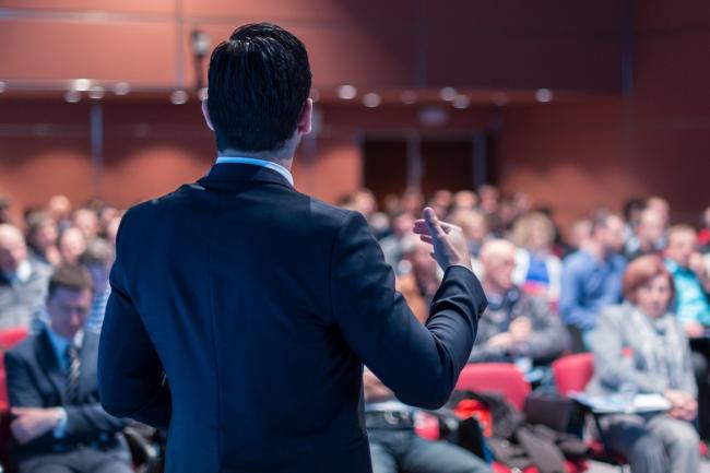 Influencer giving a speech at a corporate learning event