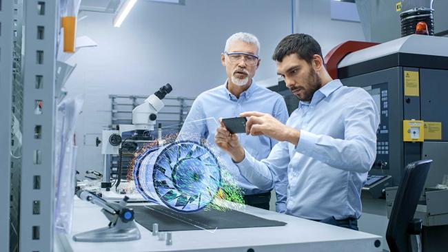 Augmented reality can be used to train safely in machine shops Two workers engage in training with augmented reality