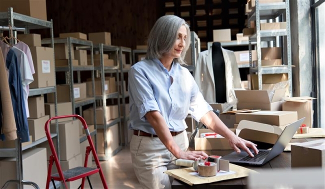 woman in front of clothing materials