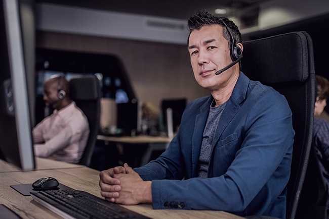 A customer support representative at his word station