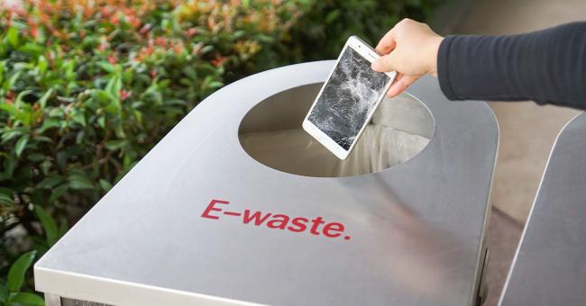 5 Best Practices and Benefits for Manufacturers Adopting Right to Repair Hand drops a broken smartphone into an e-waste bin