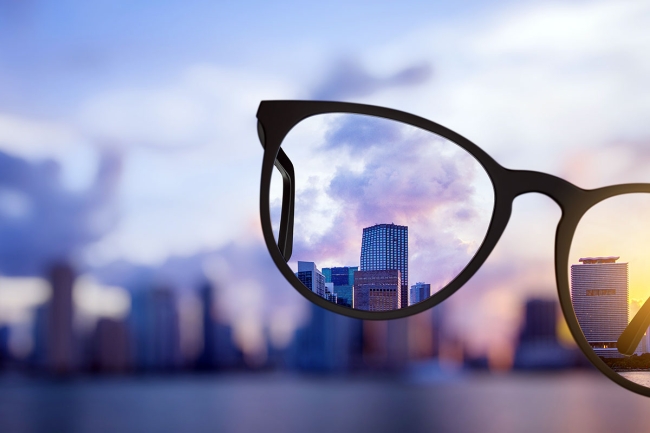 Addressing blind spots in L&D Image of eyeglasses bringing into focus a distant city