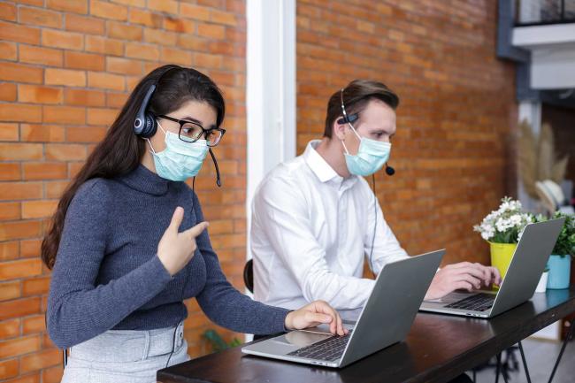 Effective call centers use people, processes and technologies Call center representatives working in masks