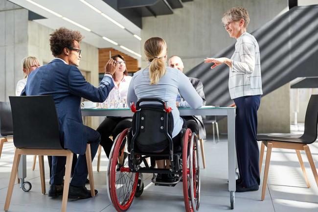 Employees of different backgrounds and different ages meet in an office Diverse and inclusive office meeting