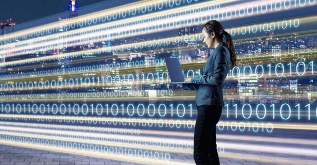 3 Practices for Digital Transformation of Learning Image of woman on laptop on city street information highway