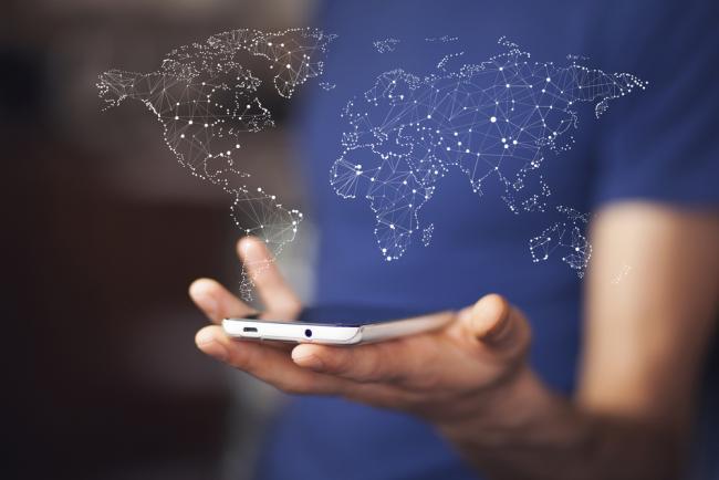 BlueCherry Next launch image Man holding smartphone with world map