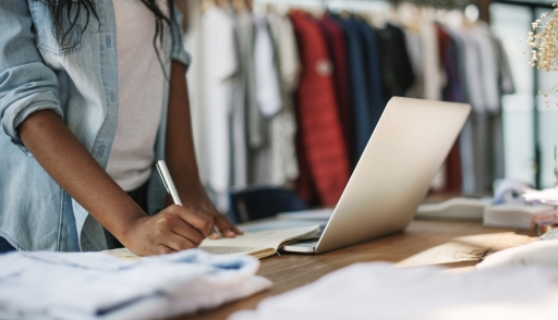 retail industry, retail store planning, designer checking clothing inventory