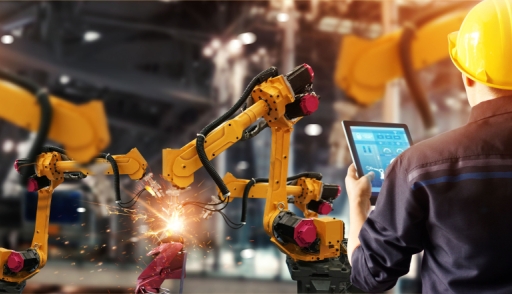 Engineer check and control welding robotics automatic arms machine in intelligent factory automotive industrial with monitoring system software.