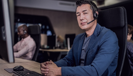 A customer support representative at his word station