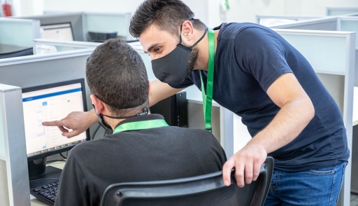 Call center trainer and employee in masks