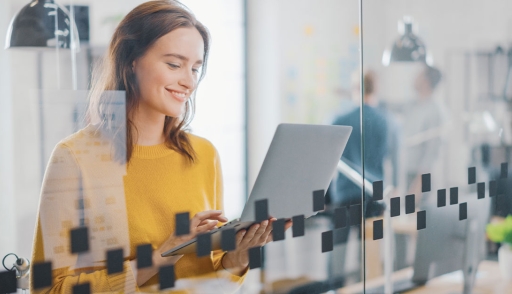 Fashion designer working on laptop in modern office