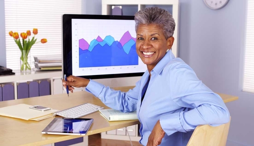 Executive at desk with tablet and computer