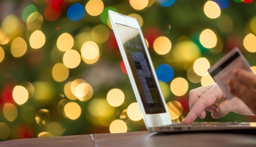 Person doing holiday shopping using credit card on laptop