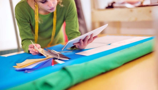 Young fashion designer works on tablet